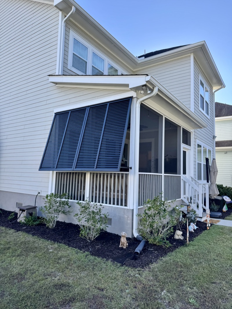 Dark Bahama shutters providing shade on a Charleston porch