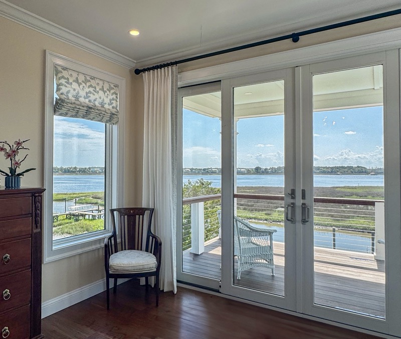 Elegant custom drapery panels framing tall windows in a Charleston living room