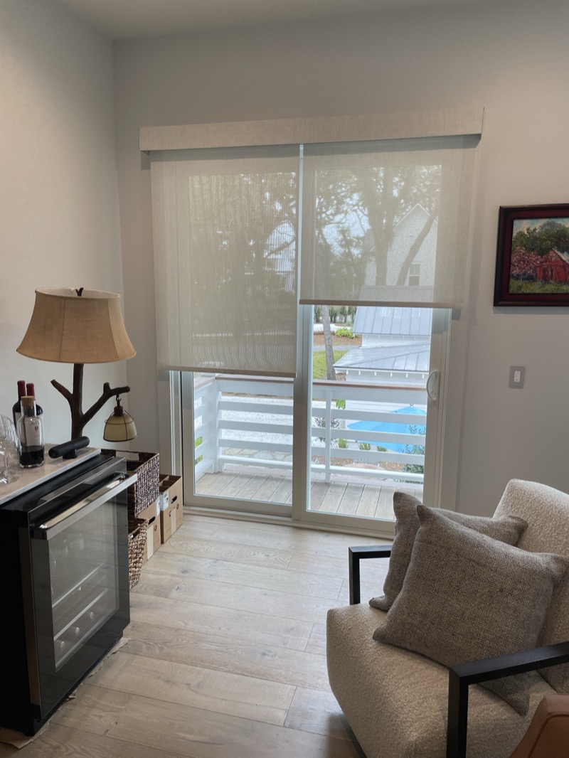 Woven wood roller shades adding warmth to a modern Charleston home