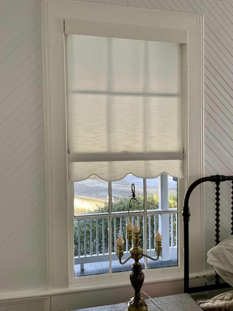 Motorized roller shades in a bright Charleston sunroom with smart home control
