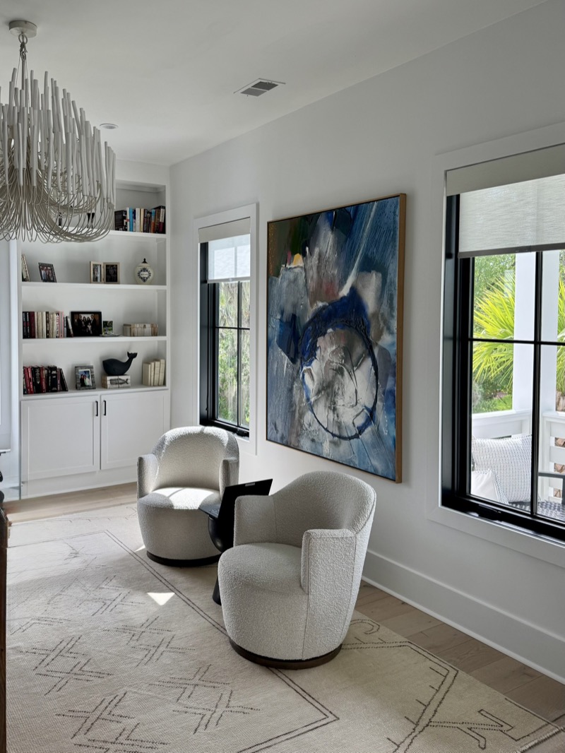 Modern roller shades on black-framed windows in a contemporary Charleston living room